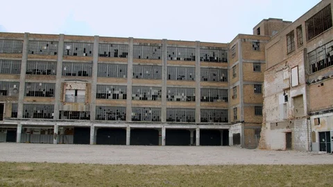 Weathered industrial building with broken windows. panning shot. 4k60p Stock Footage 130149270