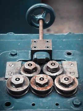 Weathered industrial machine rollers with rusted bolts and nuts on painted .. Stock-Fotos