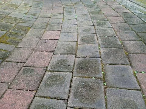 Weathered interlocking concrete paving stones in curved pattern, outdoor si.. Stock Photos