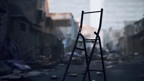A weathered ladder stands alone in a desolate urban landscape at dusk Stock Footage 312573752