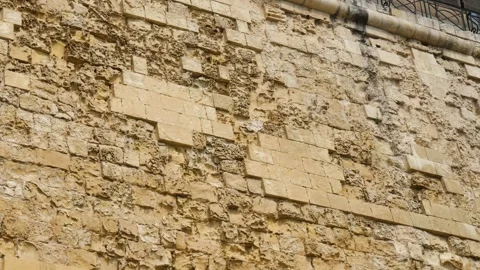 Weathered limestone masonry blocks form a valletta bastion wall close texture Stock Footage 341801478