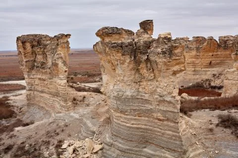 Weathered limestone pillars and vertical rock face Stock Photos