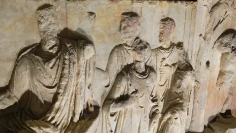 Weathered marble relief row draped classical figures high faces eroded by time Stock Footage 324893521