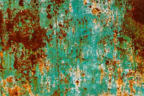 Weathered metal surface with rust and peeling paint outdoors Фото