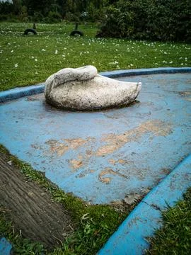 Weathered miniature golf obstacle on a worn blue course Stock Photos