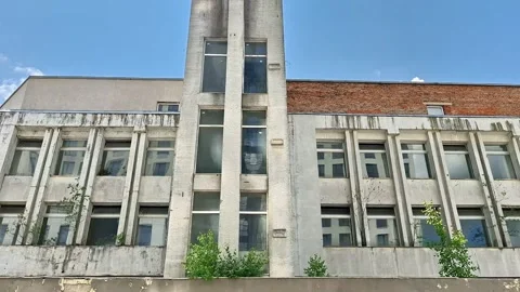 Weathered Modernist Building Facade with Tall Windows Vídeos de archivo 343705491
