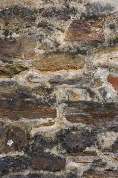 Weathered natural stone wall texture with rustic masonry pattern background Stock-Fotos