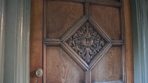 Weathered oak door with sun face motif Stock Footage 333713083