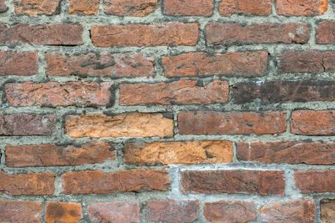 Weathered old red brick background with rough surface. Stock Photos