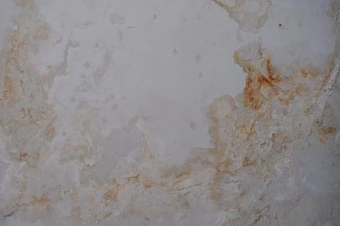 Weathered Pale Gray Wall with Rust Stains and Rough Texture Stock Photos