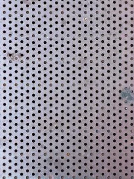 Weathered Perforated Metal Sheet with Repeating Circular Holes Stock Photos