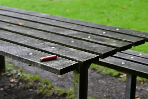 Weathered Picnic Table with Red Lighter Stock Photos