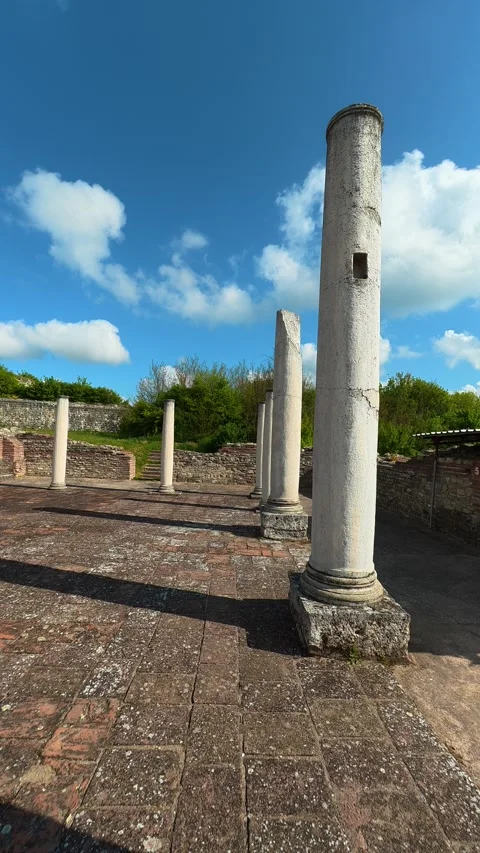 Weathered pillars stretch across paved ruins. Felix Romuliana, Vertical POV. Stock Footage 335938938
