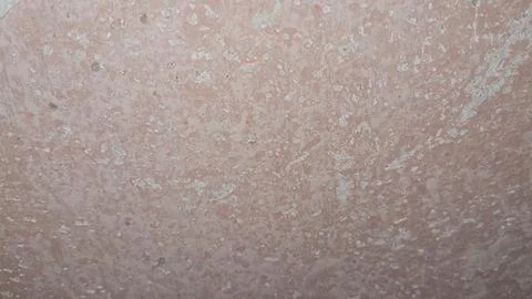 Weathered pink concrete wall surface with chipped paint and texture Stock Photos