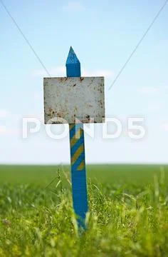 Weathered plaque on a grassy land plot Stock Photos