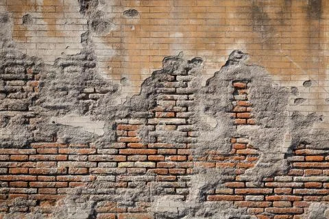 Weathered plaster and brick wall textured background Stock Photos
