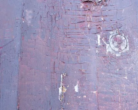 Weathered purple colored paint on rustic wooden panel Stock Photos