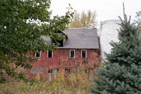 Weathered red barn with silo Stock Photos