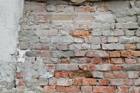 Weathered red brick wall background with spots Stock Photos