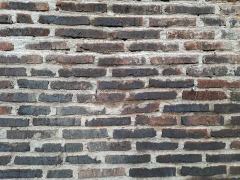 Weathered red brick wall background with rough gray cement mortar Stock Photos