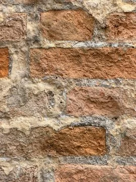 Weathered Red Brick Wall with Crumbling Mortar and Aged Plaster Stock Photos