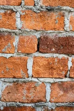 Weathered Red Brick Wall With Rough Mortar Texture Closeup Foto stock