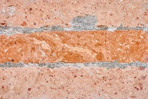 Weathered red brick wall texture with crumbling mortar, creating a rustic and Stock Photos