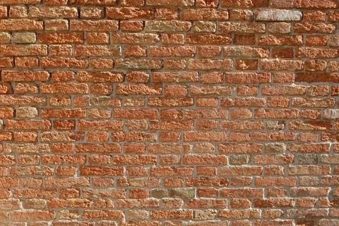 Weathered red brick wall texture in Venice Italy as background copy space Fotos Stock