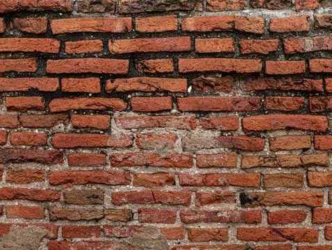 Weathered Red Brick Wall with Uneven Mortar Texture, Rustic Old Masonry Bac.. Stockfoto's