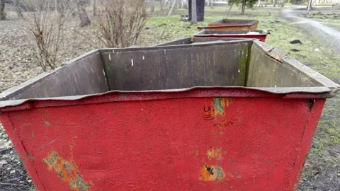 Weathered Red Containers Set Against a Natural Background in a Beautiful Outdoor Stock Footage 305279268