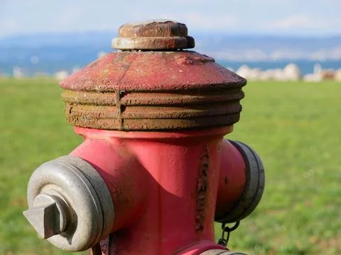 Weathered Red Fire Hydrant Near the Sea Stock Photos