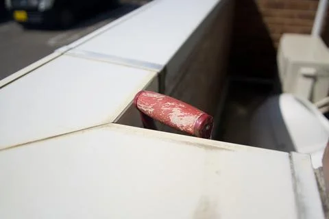 Weathered Red Metal Handle on Rooftop Railing Photos