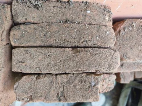 Weathered, Reddish-brown Bricks Stacked, Showcasing Rustic Texture and Debris Stock Photos