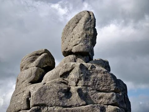 Weathered rock formation against a cloudy sky Stock Photos