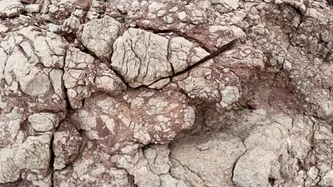 Weathered rock surface with natural cracks and textured geological patterns Stock Footage 335306261