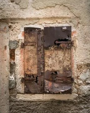 Weathered shutter and window of a stone house in Cres Stock Photos