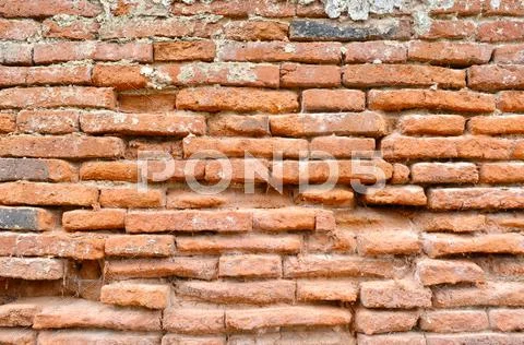 Weathered stained old brick wall background Stock Photos