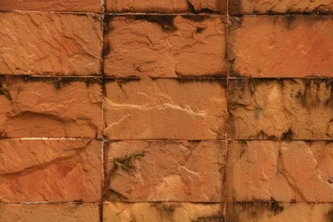 Weathered stained old brick wall background. Stock Photos