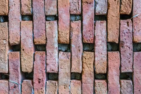 Weathered stained old brick wall background. Stock Photos