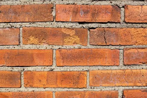 Weathered stained old brick wall background with cement and small stones between Stock Photos