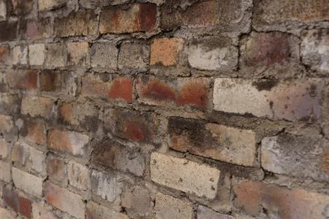 Weathered stained old brick wall background Stock Photos