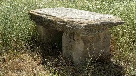 Weathered stone bench among wild herbs in a farming area of Spain Stock-Fotos