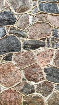 Weathered stone blocks with light mortar create a rugged architectural surfac Stock Photos