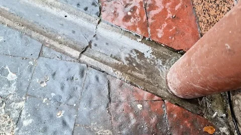 Weathered Stone Pavement with Drainage Pipe and Cracked Concrete Joint Surface Vídeos de archivo 346677862