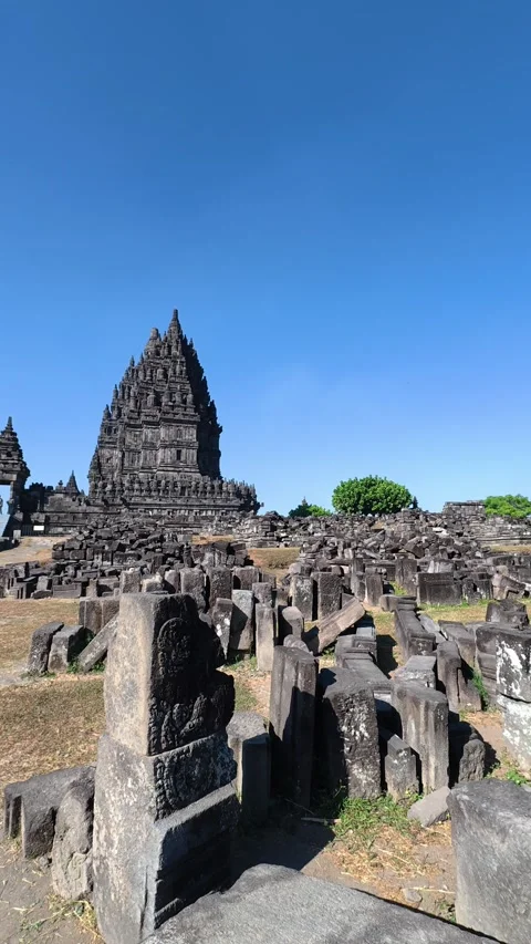 Weathered stone ruins fill the foreground beneath a solitary tower in the a.. Stock Footage 341546662