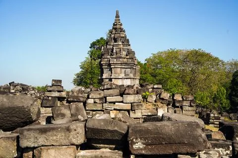 Weathered stone ruins surround a small historic shrine within the extensive.. Photos