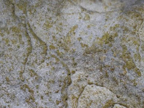 Weathered stone surface with rust-colored patches Stock Photos