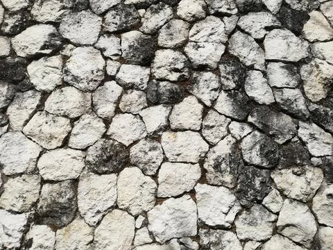 Weathered stone wall in close up Stock Photos