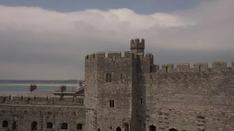 Weathered stone walls at Caernarfon Castle, highlighting textures, cracks, and Stock Footage 346018477