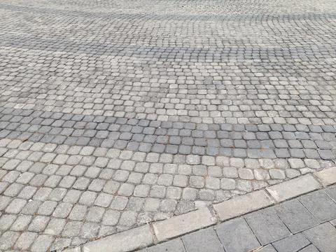 Weathered Surface of Gray Cobblestone Pavement with Curved Pattern Stock Photos